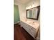 Bathroom features a dual sink vanity with a decorative mirror and hardwood flooring at 2540 Heritage Cir, Statesville, NC 28625