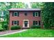 Charming two-story brick home with black shutters and lush green landscaping at 2540 Heritage Cir, Statesville, NC 28625