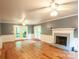 Spacious living room with fireplace and hardwood floors, leading to a back deck at 2540 Heritage Cir, Statesville, NC 28625