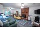 Cozy living room with brick fireplace, comfortable seating, and ample natural light, ideal for relaxation and gatherings at 2540 Heritage Cir, Statesville, NC 28625