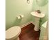 Convenient powder room with pedestal sink and wood-look flooring at 2540 Heritage Cir, Statesville, NC 28625