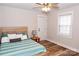 Bright bedroom featuring a comfortable bed, hardwood floors, and a window providing natural light at 2693 Salem Church Rd, Lincolnton, NC 28092