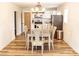 Dining area featuring a modern chandelier, wood-look floors, and stainless steel appliances at 2693 Salem Church Rd, Lincolnton, NC 28092