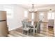Open-concept dining area adjacent to the kitchen with a table set for six and ample natural light at 2693 Salem Church Rd, Lincolnton, NC 28092