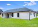 The backyard features lush green grass, a patio, and a modern house with black window frames at 28647 Nc Hwy 73 Hwy, Albemarle, NC 28001