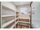 Well-organized pantry with ample shelving and a window for natural light at 28647 Nc Hwy 73 Hwy, Albemarle, NC 28001