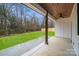 Covered patio with stained wood ceiling, overlooking a grassy yard and treelined property at 28647 Nc Hwy 73 Hwy, Albemarle, NC 28001