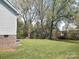 A spacious backyard featuring mature trees and lawn at 295 Green Meadows Dr, Taylorsville, NC 28681