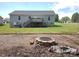 Backyard view of a two-story home featuring a fire pit and deck with stairs at 295 Green Meadows Dr, Taylorsville, NC 28681