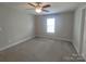 This spacious bedroom has a ceiling fan and a large window at 295 Green Meadows Dr, Taylorsville, NC 28681
