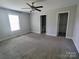 Spacious bedroom featuring neutral carpet, ceiling fan, and ensuite bathroom at 295 Green Meadows Dr, Taylorsville, NC 28681