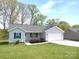 Charming single-story home with a well-maintained lawn and attached two-car garage at 295 Green Meadows Dr, Taylorsville, NC 28681