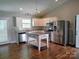 Bright kitchen with stainless steel appliances, a kitchen island, and granite countertops at 295 Green Meadows Dr, Taylorsville, NC 28681