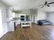 Open-concept kitchen featuring a kitchen island, white cabinets, and stainless steel appliances at 295 Green Meadows Dr, Taylorsville, NC 28681