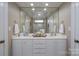 Elegant bathroom with double sinks, white cabinets, and a large mirror providing ample space and light at 302 Patterson'S Bridge None, New London, NC 28127