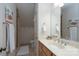 Neutral colored bathroom showcasing a wooden vanity with a bright mirror and decor at 302 Patterson'S Bridge None, New London, NC 28127