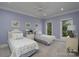 Charming bedroom with two twin beds, light blue walls, and bright windows offering serene views at 302 Patterson'S Bridge None, New London, NC 28127