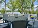 Outdoor deck features dining table and chairs with wooded waterfront views at 302 Patterson'S Bridge None, New London, NC 28127