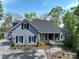 Inviting exterior of home featuring gray siding, lush landscaping, and stone pathway at 302 Patterson'S Bridge None, New London, NC 28127