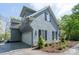 Angle shot of a home's side showcasing white garage door, beautiful landscaping, and siding at 302 Patterson'S Bridge None, New London, NC 28127