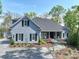 Beautiful two-story home showcasing manicured landscaping, stamped concrete drive, and a covered porch at 302 Patterson'S Bridge None, New London, NC 28127