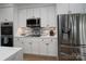 Modern white kitchen featuring stainless steel appliances and stone tile backsplash at 302 Patterson'S Bridge None, New London, NC 28127