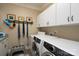 Functional laundry room features modern washer and dryer, overhead cabinets, and convenient pet feeding station at 302 Patterson'S Bridge None, New London, NC 28127