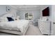 Bright and airy main bedroom features a ceiling fan, mounted TV, and white furniture at 302 Patterson'S Bridge None, New London, NC 28127