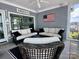 Screened-in porch with comfortable seating and lake views at 302 Patterson'S Bridge None, New London, NC 28127