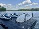 Watercraft including two jet skis and a surfboard on a floating platform in the water at 302 Patterson'S Bridge None, New London, NC 28127