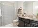 This bathroom showcases a stylish vanity, tasteful decor, and a striped shower curtain, blending aesthetics and functionality at 3028 Quinebaug Rd, Fort Mill, SC 29715