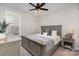 The bedroom features modern decor, a ceiling fan, and plush bedding for a comfortable and stylish retreat at 3028 Quinebaug Rd, Fort Mill, SC 29715