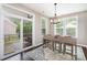 Bright breakfast nook with outdoor access, a modern light fixture, and a breakfast table at 3028 Quinebaug Rd, Fort Mill, SC 29715