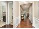 Elegant hallway with hardwood floors, detailed trim, and views into other rooms of the open-concept layout at 3028 Quinebaug Rd, Fort Mill, SC 29715
