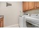 Well-equipped laundry room with modern washer and dryer units, along with counter space and storage cabinets at 3028 Quinebaug Rd, Fort Mill, SC 29715