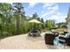 Expansive patio with outdoor seating, dining set, and scenic wooded views at 3028 Quinebaug Rd, Fort Mill, SC 29715
