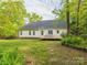Back exterior of home features a lush green yard and a wooden deck at 3033 Beech Ct, Indian Trail, NC 28079