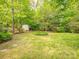 The backyard offers a shed and lush lawn surrounded by trees, offering privacy at 3033 Beech Ct, Indian Trail, NC 28079