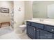 Renovated bathroom features a blue vanity, white tile floors, and nautical decor at 3033 Beech Ct, Indian Trail, NC 28079