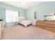 Bright bedroom features a comfortable bed, pale blue walls, neutral carpet, and large windows at 3033 Beech Ct, Indian Trail, NC 28079