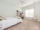Comfortable bedroom with a hanging chair, desk, shelving, and lots of natural light at 3033 Beech Ct, Indian Trail, NC 28079