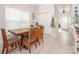 Charming dining room with tile floors, a wooden table, and a large window for natural light at 3033 Beech Ct, Indian Trail, NC 28079