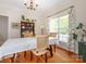 Bright dining room with hardwood floors, chandelier lighting, and a large window view at 3033 Beech Ct, Indian Trail, NC 28079