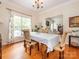 Elegant dining room featuring hardwood floors, large windows, and a view to the living area at 3033 Beech Ct, Indian Trail, NC 28079