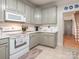 Kitchen featuring gray cabinets, white countertops, modern appliances, and a stylish range at 3033 Beech Ct, Indian Trail, NC 28079