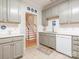 Well-lit kitchen with gray cabinetry, white countertops, and views of the staircase at 3033 Beech Ct, Indian Trail, NC 28079