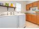 This spacious laundry room boasts wooden cabinets, a sink, and modern appliances at 3033 Beech Ct, Indian Trail, NC 28079