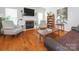 Spacious living room featuring a cozy fireplace, hardwood floors, and neutral decor at 3033 Beech Ct, Indian Trail, NC 28079
