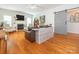 Open-concept living room with hardwood floors, fireplace, and barn door access at 3033 Beech Ct, Indian Trail, NC 28079