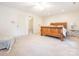 Large main bedroom features a wooden bed frame, neutral carpet, and ample space at 3033 Beech Ct, Indian Trail, NC 28079